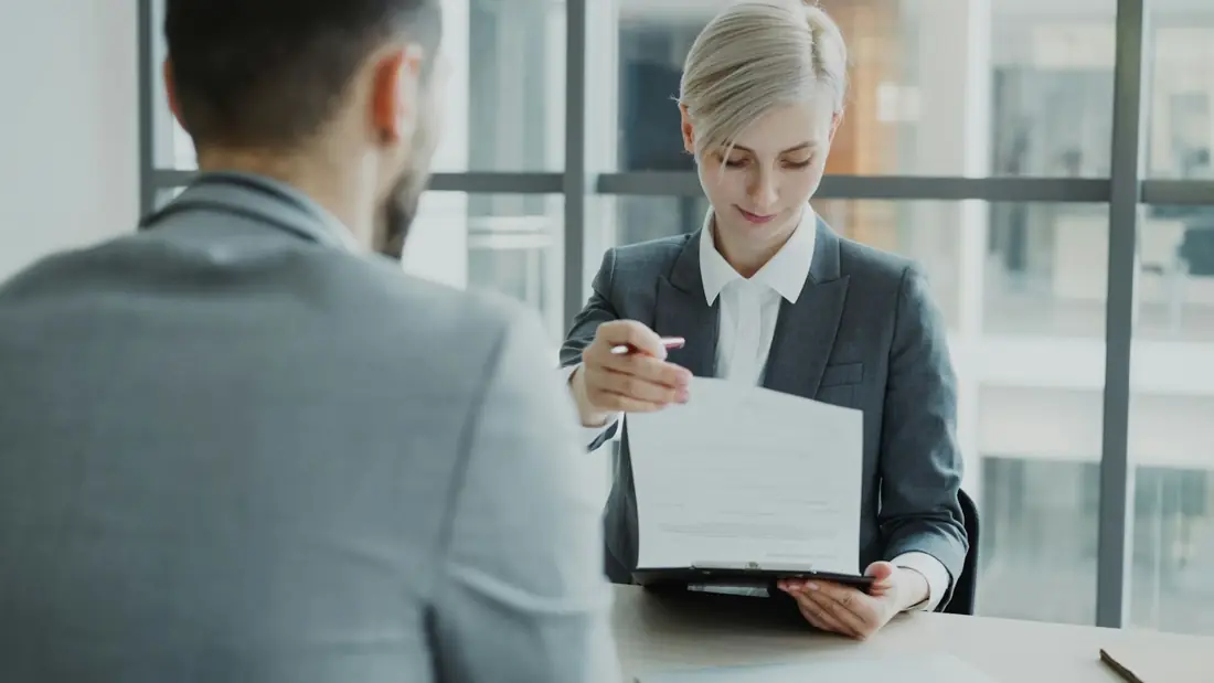 A specialist reviewing a document with a client
